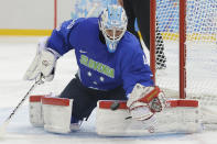 Slovenia goaltender Luka Gracnar stops a shot on the goal during the 2014 Winter Olympics men's ice hockey game against USA at Shayba Arena Sunday, Feb. 16, 2014, in Sochi, Russia. (AP Photo/Matt Slocum)