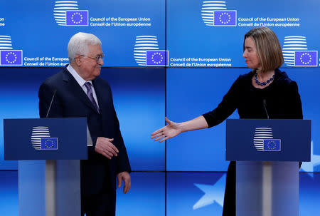 European High Representative for Foreign Affairs Federica Mogherini shakes hands with Palestinian President Mahmoud Abbas in Brussels, Belgium, January 22, 2018. REUTERS/Yves Herman