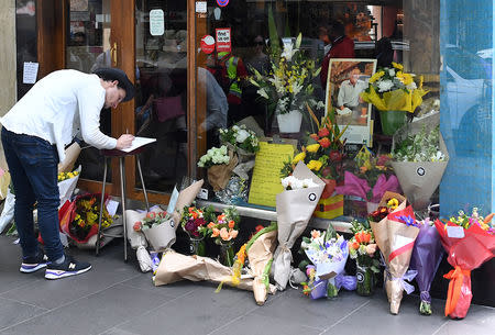 Floral tributes can be seen outside Melbourne's Pellegrini's Cafe for Sisto Malaspina, the day after he was stabbed to death in an attack police have called an act of terrorism, in central Melbourne, Australia, November 10, 2018. AAP/James Ross/via REUTERS