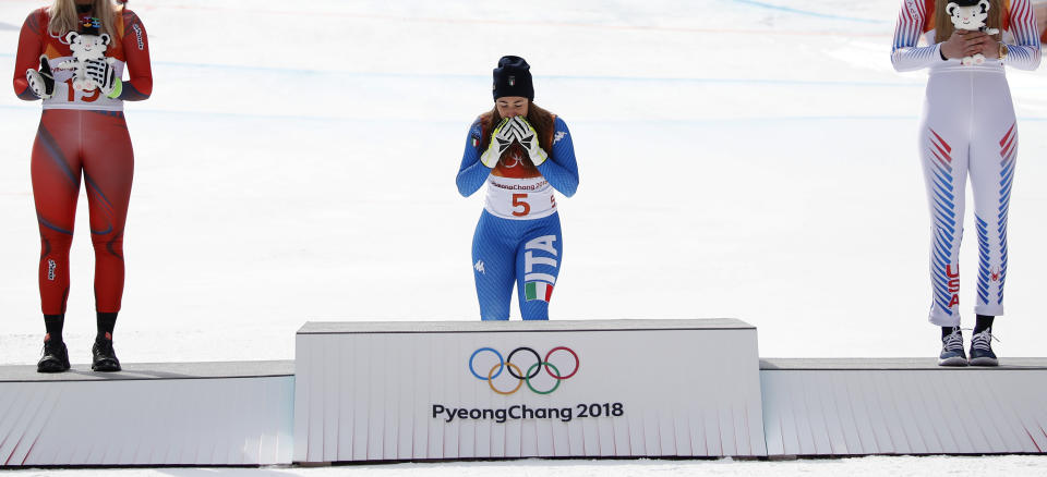 <p>Gold medal winner Sofia Goggia, center, becomes emotional during the flower ceremony for the women’s downhill at the 2018 Winter Olympics in Jeongseon, South Korea, Wednesday, Feb. 21, 2018. (AP Photo/Christophe Ena) </p>