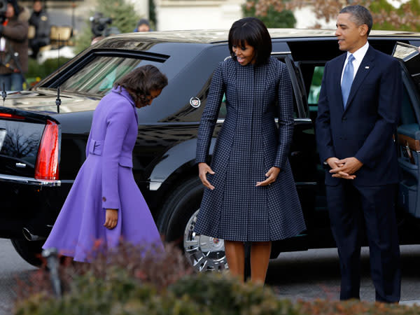 Michelle Obama joins her husband, President Barack Obama and her daughters Sasha and Malia, for the Inauguration Day ceremonies on Jan. 21, 2013. Fittingly, the First Lady wears a blue Thom Browne coat on Blue Monday! (AP Photo/Jacquelyn Martin)