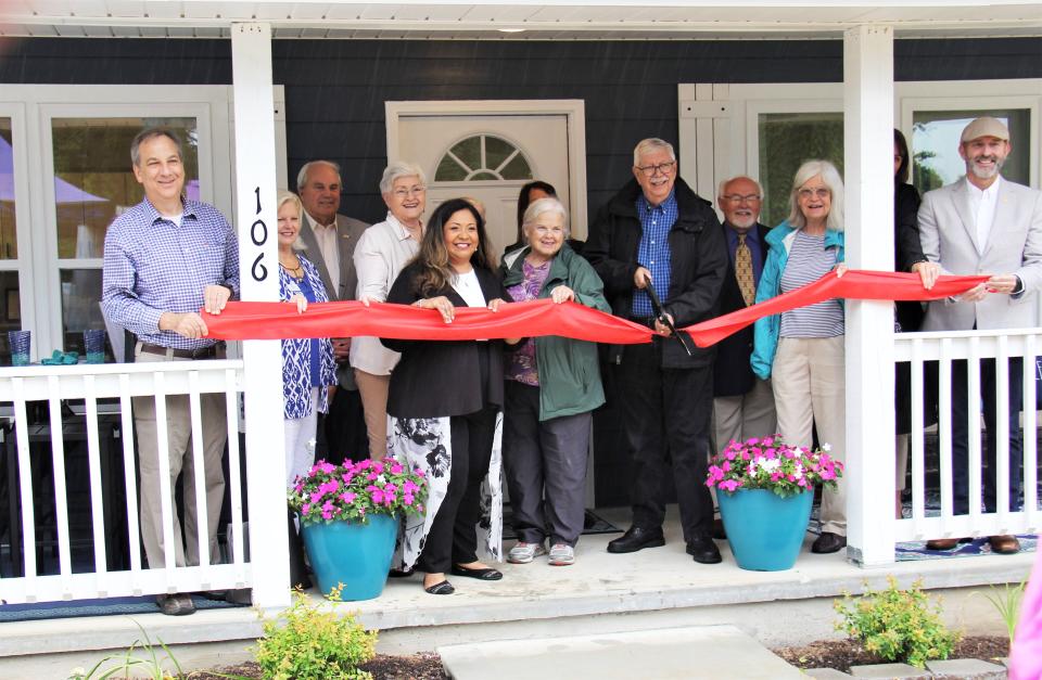 Cutting the ribbon for the grand opening of 106 Waddell Place in Oak Ridge are David Bradshaw, from left, of Pinnacle Bank; Judy Gooch, interior designer; Jean Lantrip, Oak Ridge Housing Authority Board president; Maria Catron, ORHA executive director; Sharon Crane, ORHA Board member; Tom Beehan, Oak Ridge Community Development Corp. Board president; Bill Lord, with the Tennessee Housing Development Agency, Ellen Smith, Oak Ridge City Council member; and Jim Dodson, Oak Ridge mayor pro tem.