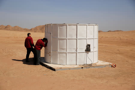 A staff member looks into a mock space capsule at the C-Space Project Mars simulation base in the Gobi Desert outside Jinchang, Gansu Province, China, April 17, 2019. REUTERS/Thomas Peter