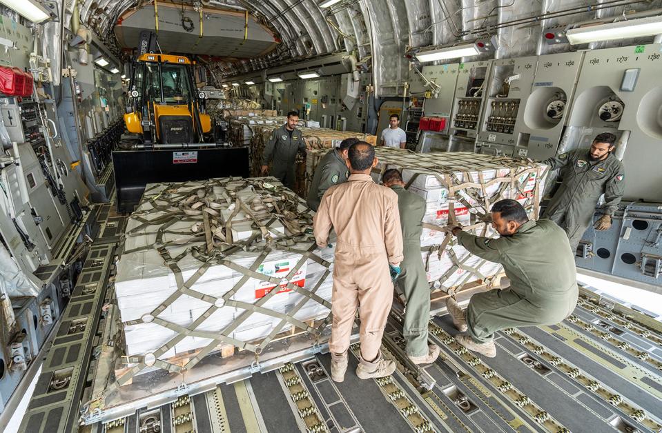 Humanitarian aid bound for the Gaza Strip being loaded into a military aircraft at the International Airport in Kuwait City on Sunday (KUNA/AFP via Getty Images)