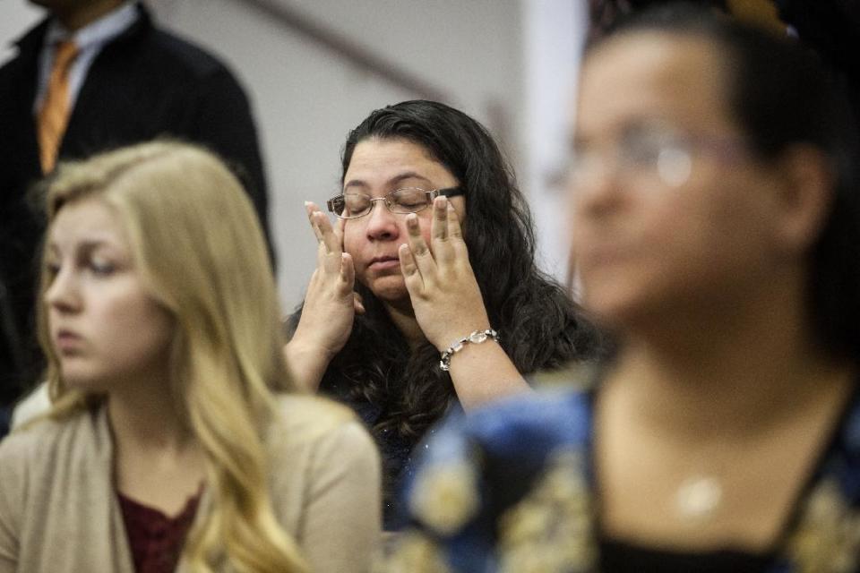 Anita Hernandez wipes away tears as names of the victims killed in the Fort Hood shooting are read aloud during a memorial service at the Tabernacle Baptist Church on Sunday, April 6, 2014 in Killeen, Texas. Investigators say that an Army truck driver, Ivan Lopez, had an argument before opening fire at the Texas post last Wednesday, killing three soldiers and wounding 16 others before taking his own life. (AP Photo/ Tamir Kalifa)