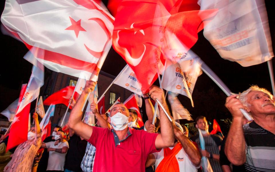 Supporters of right-wing nationalist Ersin Tatar celebrate his win in the presidential election in the northern part of Nicosia, the capital of the self-proclaimed Turkish Republic of Northern Cyprus (TRNC) - AFP