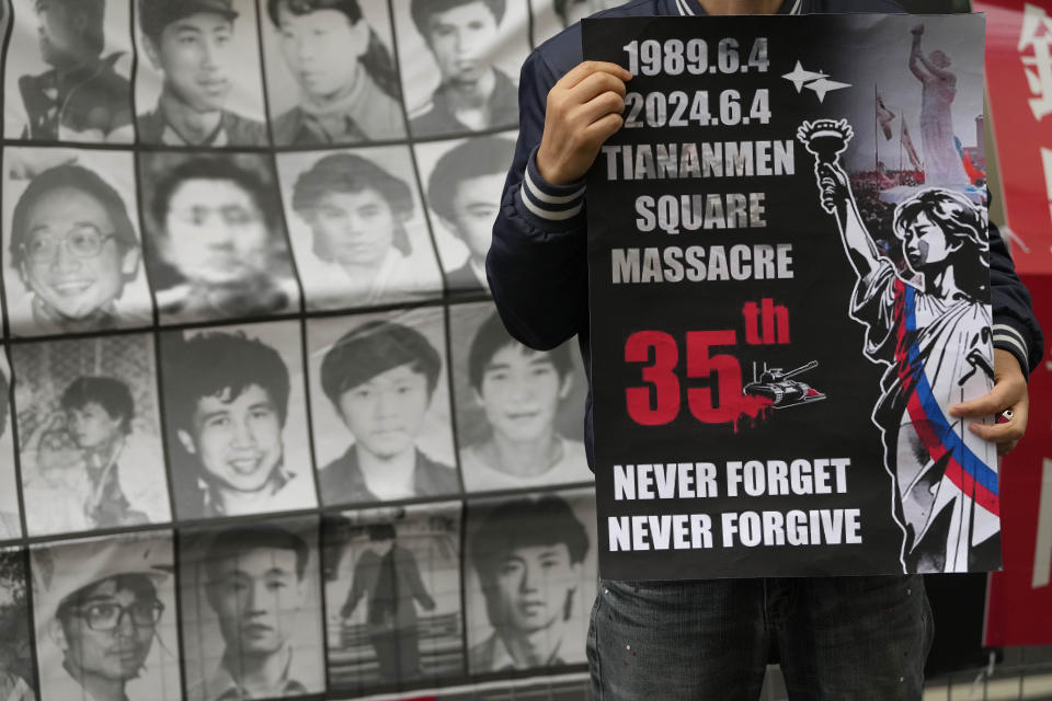 A Demonstrator holds a placard as protesters gather for a Candlelight vigil to commemorate the 35th anniversary of the 1989 pro-democracy movement and China's Tiananmen Square crackdown approaches at the Chinese embassy in London, Tuesday, June 4, 2024.(AP Photo/Kirsty Wigglesworth)