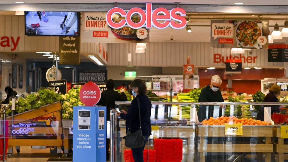 A shopper enters a Coles supermarket in Canberra