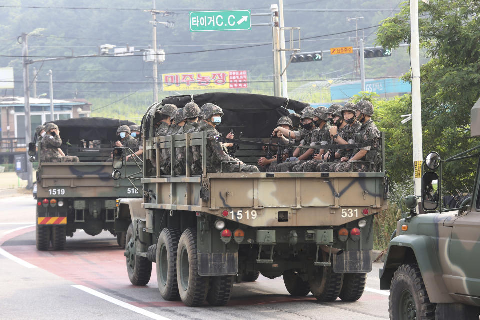 South Korean army soldiers ride on the back of trucks in Paju, near the border with North Korea, South Korea, Wednesday, June 17, 2020. North Korea said Wednesday it will redeploy troops to now-shuttered inter-Korean tourism and economic sites near the border with South Korea and take other steps to nullify landmark 2018 tension-reduction deals. (AP Photo/Ahn Young-joon)