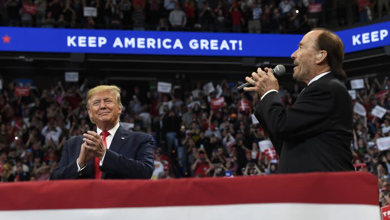 President Donald Trump listens as Lee Greenwood sings “God Bless the USA” during a campaign rally in Lexington, Ky., on Nov. 4, 2019.