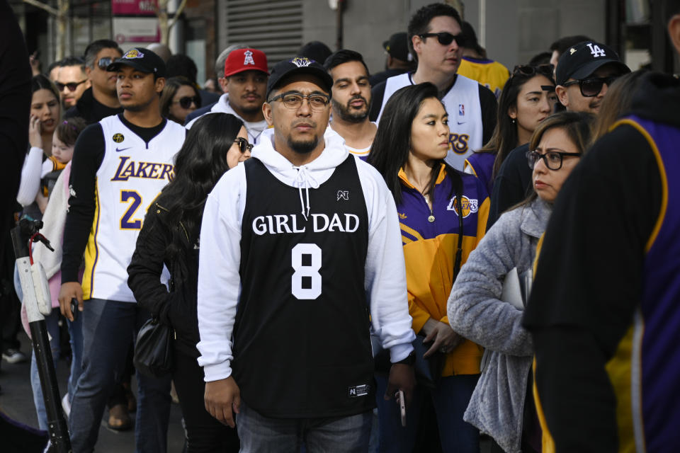 Fans wait in line near the Staples Center before the "Celebration of Life for Kobe & Gianna Bryant", in Los Angeles, Monday, Feb. 24, 2020. (AP Photo/Kelvin Kuo)