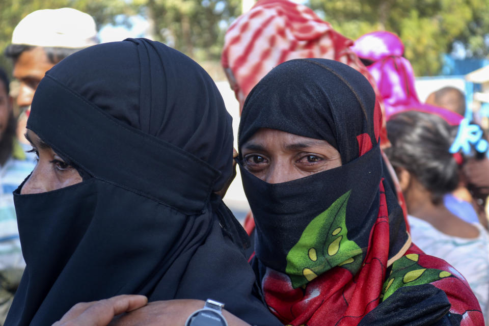 Rohingya refugees who are being moved to an island called ‘Bhasan Char’ gather outside a transit area where they are temporally housed in Ukhiya, Bangladesh, Thursday, Dec.3, 2020. (AP Photo/ Shafiqur Rahman)