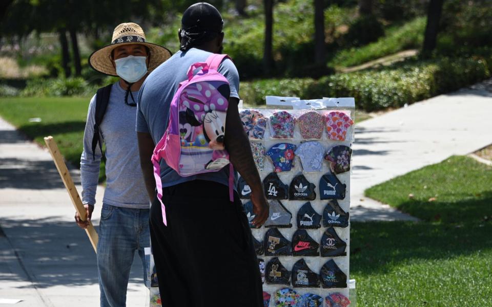 A mask seller in Burbank. Cases has surged since the state began to reopen - GETTY IMAGES