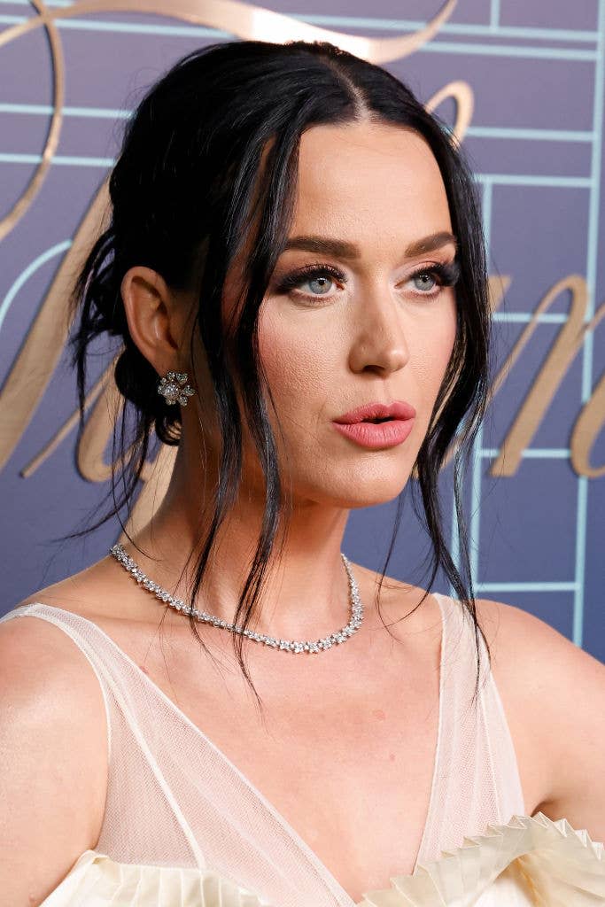 Katy Perry in an elegant gown with ruffled details, wearing a necklace and earrings