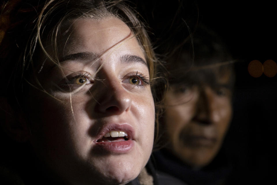 Camila Mereles, relative of submarine ARA San Juan crew member Gabriel Alfaro, waits outside the navy base in Mar del Plata, Argentina Saturday, Nov. 17, 2018. Argentina's navy announced early Saturday, that searchers found the missing submarine ARA San Juan in the Atlantic a year after it disappeared with 44 crew members aboard.(AP Photo/Federico Cosso)