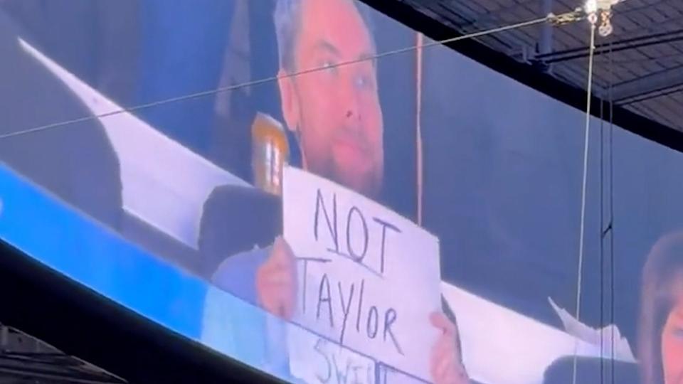 What was the deal with Bass holding up a sign that read "Not Taylor Swift" at an NFL game last fall?