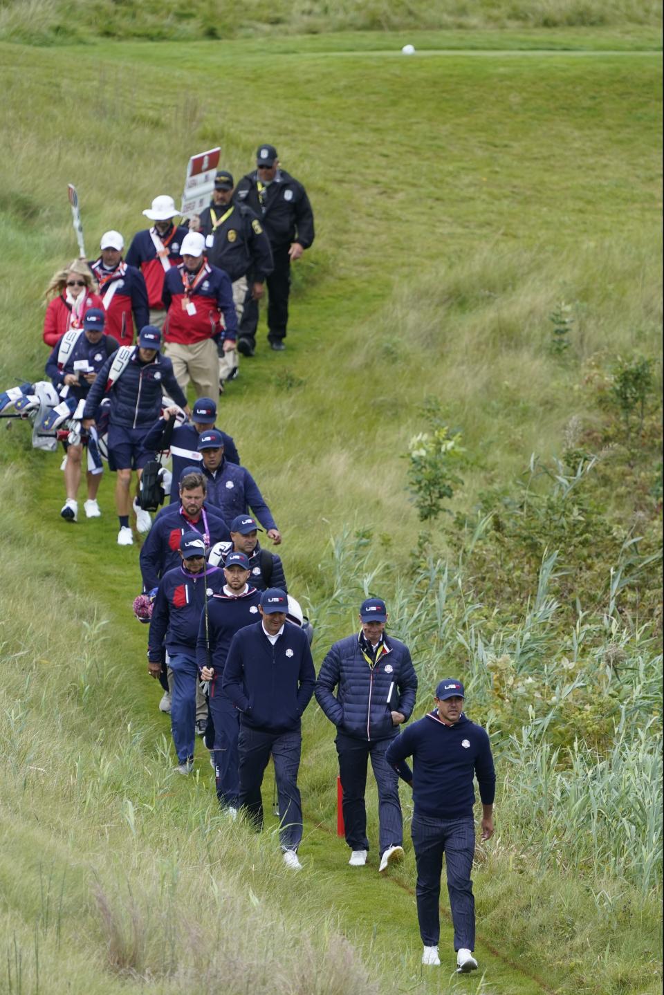 Team USA's Brooks Koepka and other team USA members walk off the 10th tee during a practice day at the Ryder Cup at the Whistling Straits Golf Course Wednesday, Sept. 22, 2021, in Sheboygan, Wis. (AP Photo/Charlie Neibergall)