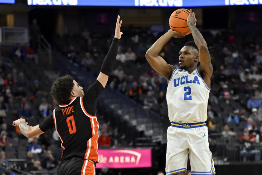 UCLA guard Dylan Andrews jumps and shoots over Oregon State's Jordan Pope during the Pac-12 tournament