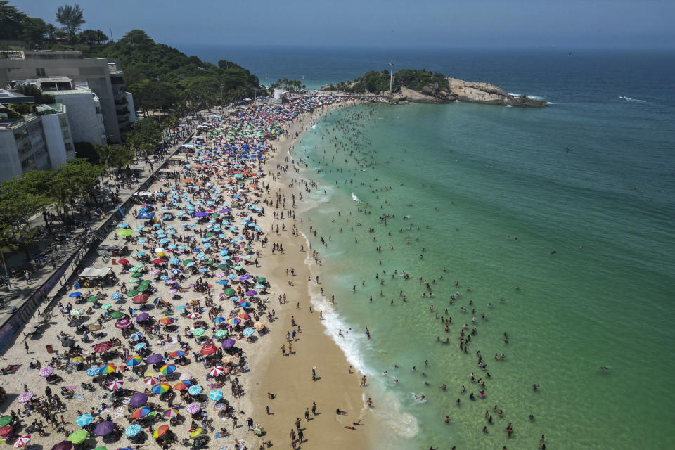 FILER - Beachgoers flock to Arpoador beach to beat the extreme heat in Rio de Janeiro, Brazil, Sunday, Sept. 24, 2023. The European climate agency calculates that November, for the sixth month in a row, the globe set a new monthly record for heat, adding the hottest autumn to the broken records of record-breaking heat this year. (AP Photo/Bruna Prado, File)