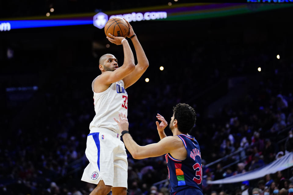 Los Angeles Clippers' Nicolas Batum, left, goes up for a shot against Philadelphia 76ers' Furkan Korkmaz during the second half of an NBA basketball game, Friday, Jan. 21, 2022, in Philadelphia. (AP Photo/Matt Slocum)