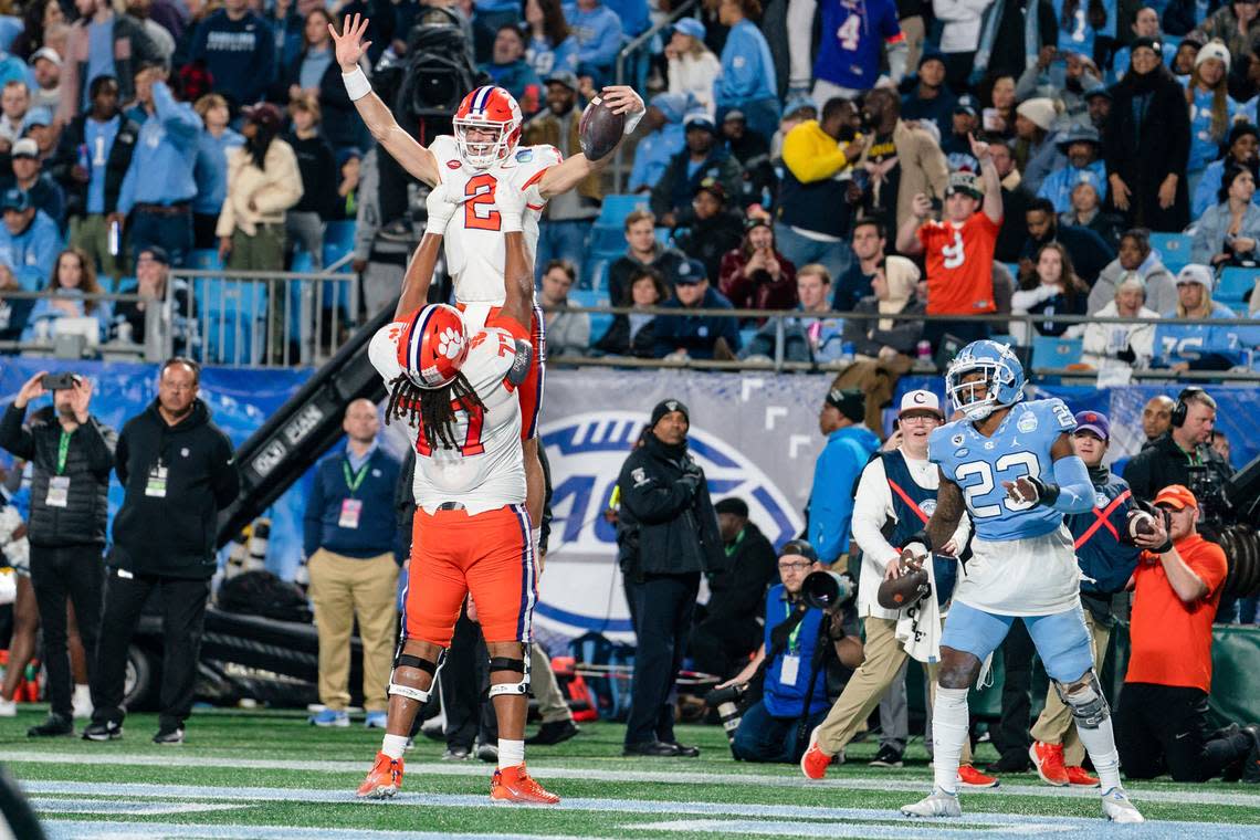 Clemson quarterback Cade Klubnik (2) celebrates after his touchdown with offensive lineman Mitchell Mayes (77) in the first half during the Atlantic Coast Conference championship NCAA college football game against North Carolina on Saturday, Dec. 3, 2022, in Charlotte, N.C. (AP Photo/Jacob Kupferman)
