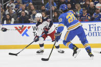 Columbus Blue Jackets' Oliver Bjorkstrand (28) handles the puck during the first period of an NHL hockey game against the St. Louis Blues on Saturday, Nov. 27, 2021, in St. Louis. (AP Photo/Michael Thomas)