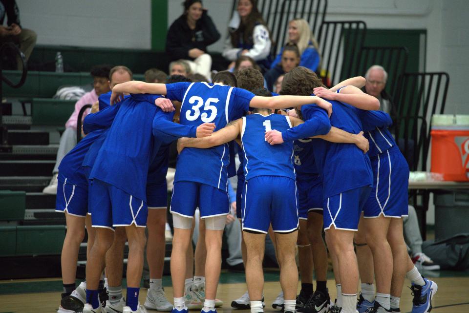 Holmdel High School's boys basketball team huddles up