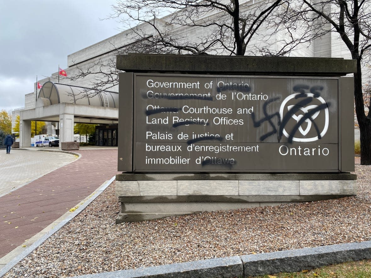 Antisemitic graffiti is seen on the sign for the provincial courthouse in Ottawa, on Nov. 15, 2021. Some Jewish community members say the non-Jewish community has been too silent regarding antisemitism.  (Simon Lasalle/CBC - image credit)