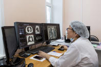 A medical worker looks at a computer tomography examination of patients suspected of having coronavirus at the hospital in Ulan-Ude, the regional capital of Buryatia, a region near the Russia-Mongolia border, Russia, Friday, Nov. 20, 2020. Russia’s health care system has been under severe strain in recent weeks, as a resurgence of the coronavirus pandemic has swept the country. (AP Photo/Anna Ogorodnik)