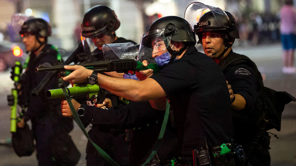 Los Angeles police can be seen trying to control the unruly crowds near Staples Center.