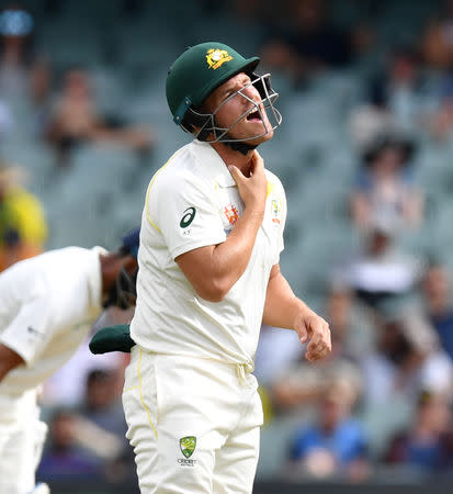 Australia's Aaron Finch reacts after being hit in the throat by the ball during day three of the first test match between Australia and India at the Adelaide Oval in Adelaide, Australia, December 8, 2018. AAP/David Mariuz/via REUTERS