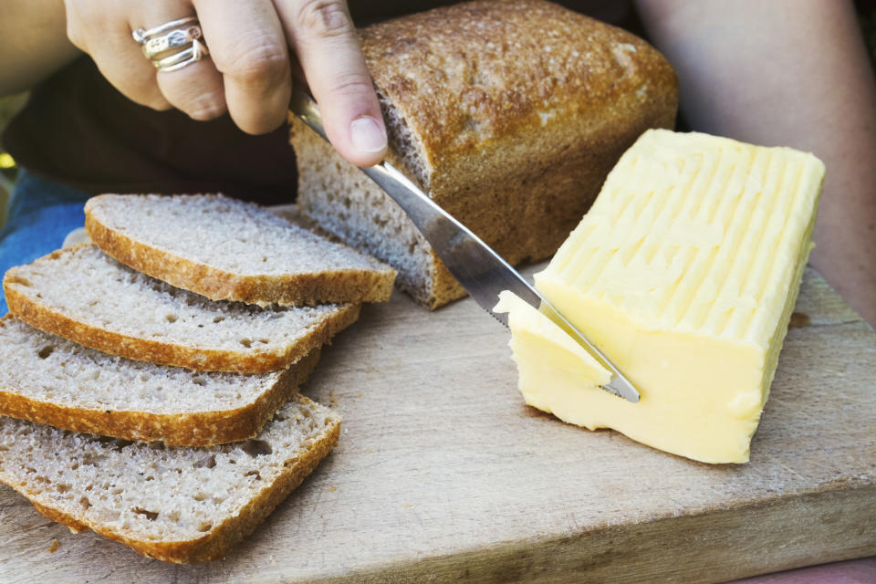 A person slicing butter.