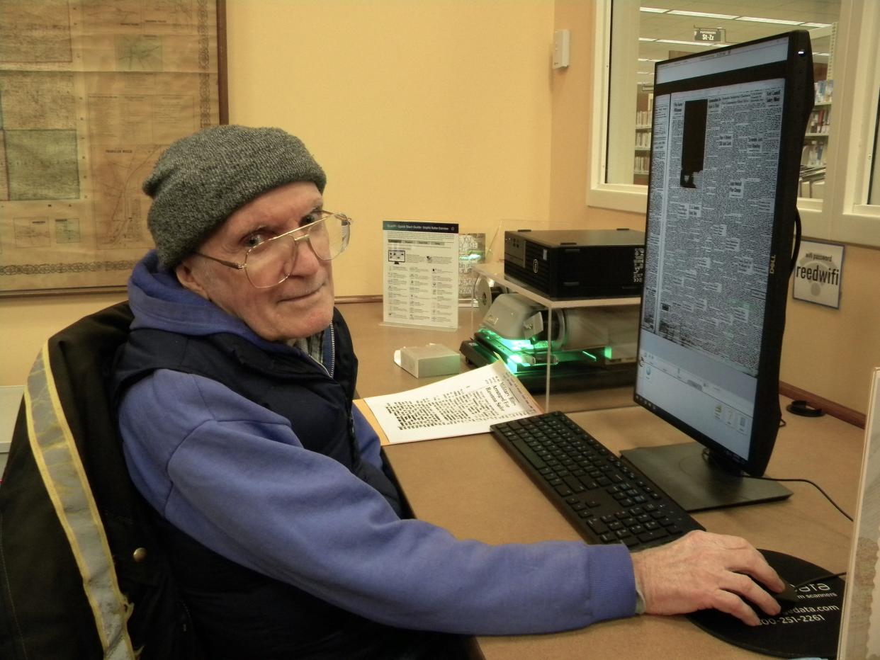 Barry Gilligan, who lives in the Hartville area, has spent the last few years attempting to research the life of Kenneth T. Smith Jr., a Ravenna resident who enlisted in the Navy and died on his ship in September 1957. Here, Gilligan is shown at Reed Memorial Library in Ravenna, where he has done some of his research.