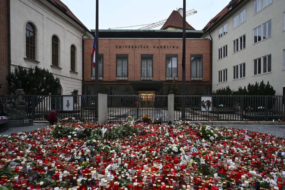 A view of floral tributes and candles left outside the headquarters of Charles University in downtown Prague, Czech Republic, Saturday, Dec. 23, 2023. A lone gunman opened fire at a university on Thursday, killing over 12 people and injuring dozens. (AP Photo/Denes Erdos)