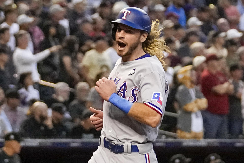 Texas Rangers' Travis Jankowski celebrates after scoring on triple by Marcus Semien during the second inning in Game 4 of the baseball World Series against the Arizona Diamondbacks Tuesday, Oct. 31, 2023, in Phoenix. (AP Photo/Brynn Anderson)
