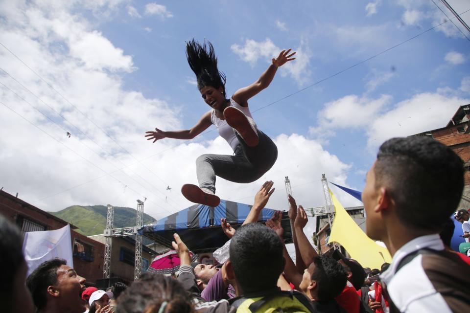 <p>Eine Frau wird während einer Wahlveranstaltung eines Pro-Regierungs-Kandidaten in Venezuela in die Luft geworfen. In ganz Venezuela wurden vor der historischen Wahl am Sonntag Abschlusskundgebungen veranstaltet. (Bild: AP Photo/Ariana Cubillos) </p>