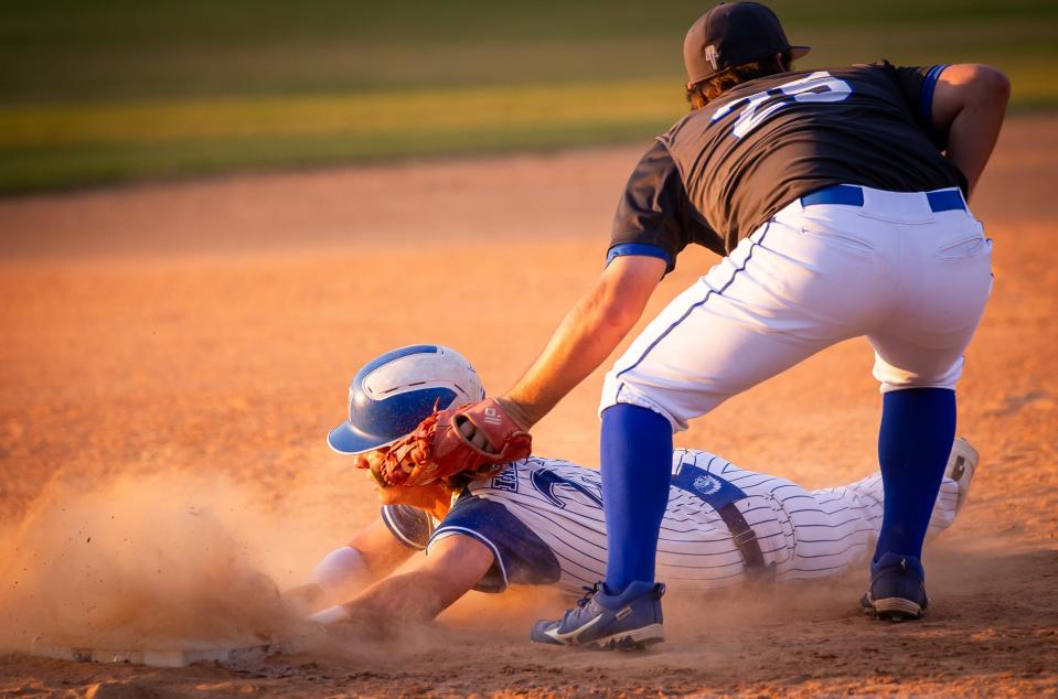 Clay's Parker Lowrance (25) tags out Keystone Heights' Austin Smith at third base during an April 25 baseball game.