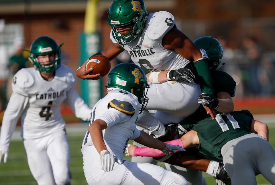 Tyson Riley, of Springfield Catholic, fights through Mount Vernon defenders in the Irish's 26-18 loss in the Class 3 Quarterfinal game at Mount Vernon High School on Saturday, Nov. 17, 2018.