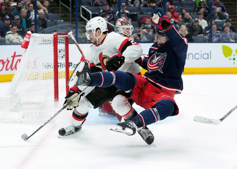 Apr 2, 2023; Columbus, Ohio, USA; Columbus Blue Jackets right wing Kirill Marchenko (86) gets knocked down by Ottawa Senators defenseman Artem Zub (2) during the third period of the NHL game at Nationwide Arena. 