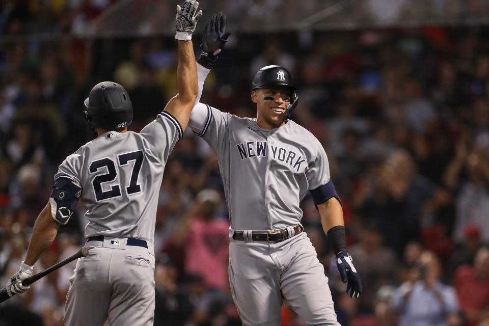 New York Yankees center fielder Aaron Judge celebrates after hitting a home run during the eighth inning against the Boston Red Sox at Fenway Park.