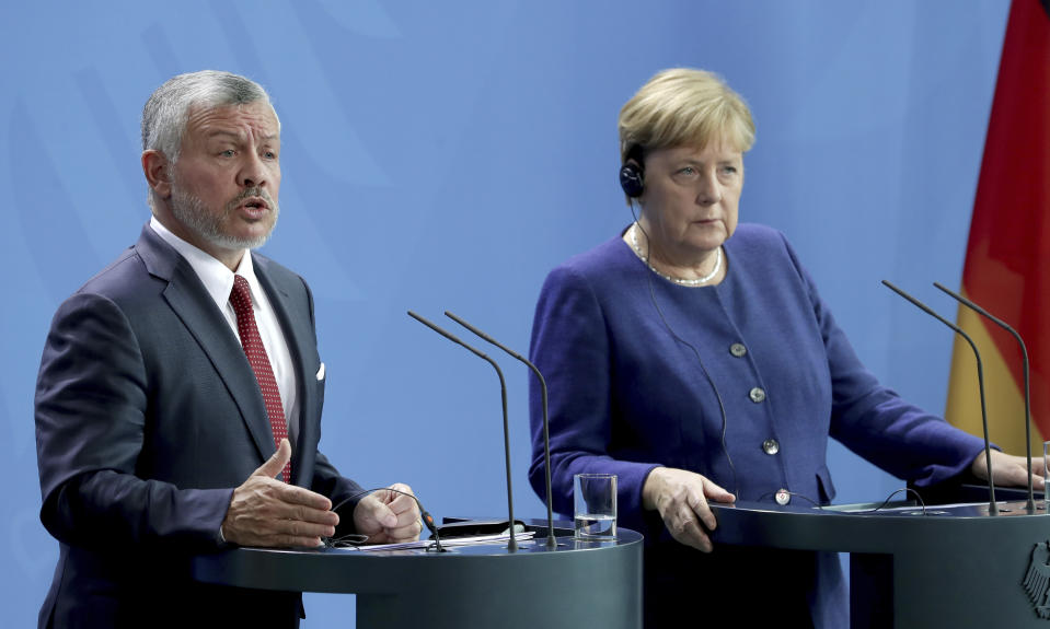 German Chancellor Angela Merkel, right, and Jordan's King Abdullah II, left, address the media during a joint press conference after a meeting at the Chancellery in Berlin, Germany, Tuesday, Sept. 17, 2019. (AP Photo/Michael Sohn)