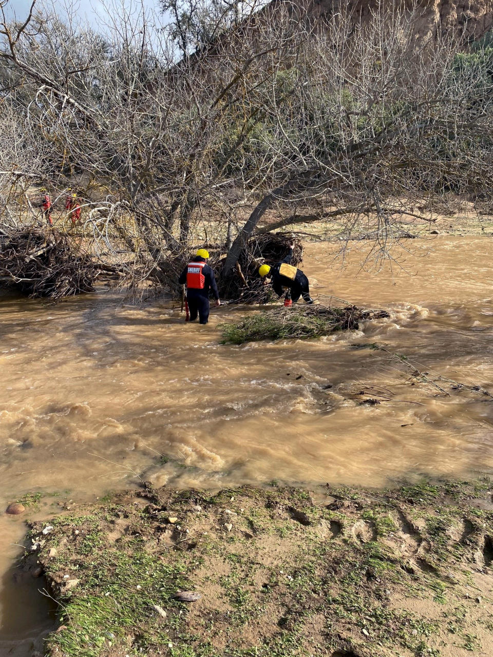 In this photo provided by San Luis Obispo County Sheriff's Office, rescuers resume their search on Wednesday, Jan. 11, 2023, for 5-year-old Kyle Doan, who was swept away Monday, Jan. 9, by floodwaters near San Miguel, Calif. (San Luis Obispo County Sheriff's Office via AP)