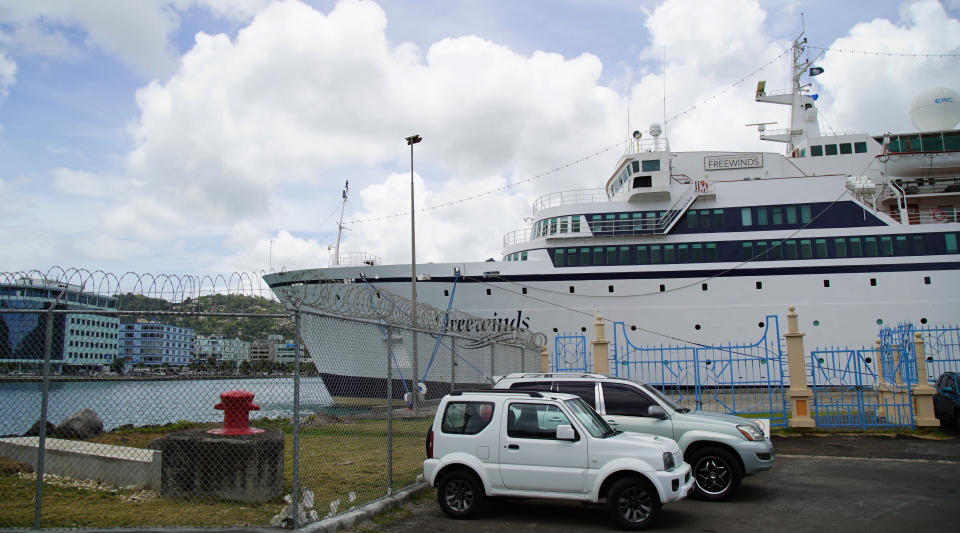 The Freewinds cruise ship is docked in the port of Castries, the capital of St. Lucia, Thursday, May 2, 2019. Authorities in the eastern Caribbean island have quarantined the ship after discovering a confirmed case of measles aboard. (AP Photo/Bradley Lacan)