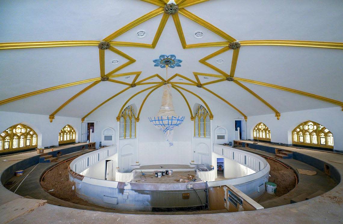 The dark wood interior of the 100-year-old former Broadway Baptist Church, 39th Terrace and Broadway Boulevard, has been renovated and painted white and gold, the pews split to create a center aisle.