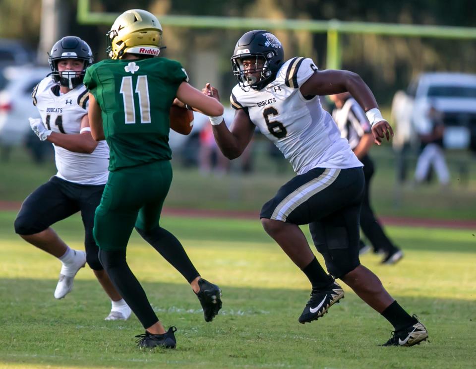 Buchholz High School Gavin Hill (6) goes after Trinity Catholic quarterback Alan Means (11) as Buchholz travels to Trinity Catholic high school for a preseason game in Ocala, Florida on Friday August 19, 2022.  [Alan Youngblood/Special to the Ocala Star-Banner]