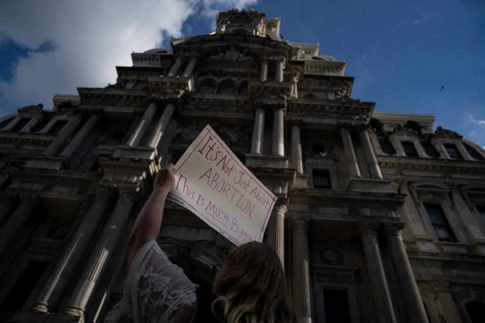 Person holds up sign "It's not just about abortion, this is much bigger"