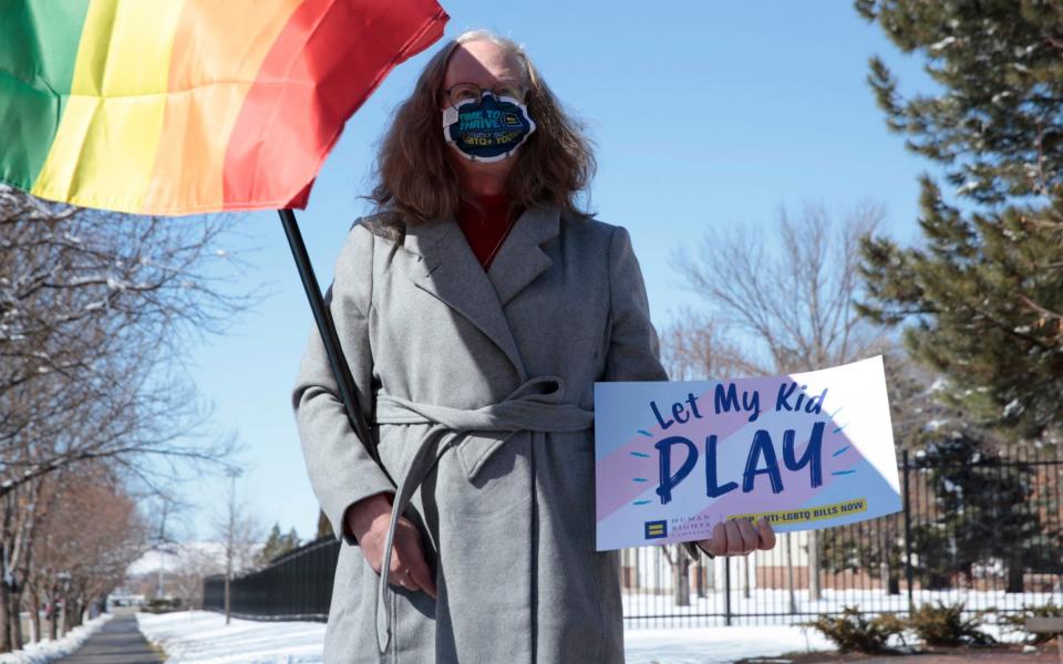 Stephanie Marty demonstrates against a proposed ban on transgender girls and women from female sports leagues outside the South Dakota governor's mansion - AP