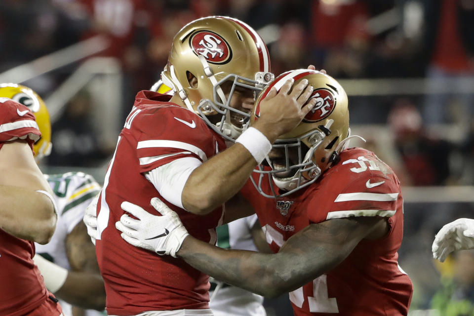 San Francisco 49ers running back Raheem Mostert, right, celebrates his touchdown with quarterback Jimmy Garoppolo during the second half of the NFL NFC Championship football game against the Green Bay Packers Sunday, Jan. 19, 2020, in Santa Clara, Calif. (AP Photo/Marcio Jose Sanchez)