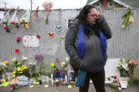Danielle Boudreaux, 40, who knew Derick Ion Almena and his children and went to the Ghost Ship many times, cries at a sidewalk memorial near the burned warehouse following the fatal fire in the Fruitvale district of Oakland, California, U.S. December 5, 2016. REUTERS/Lucy Nicholson TPX IMAGES OF THE DAY