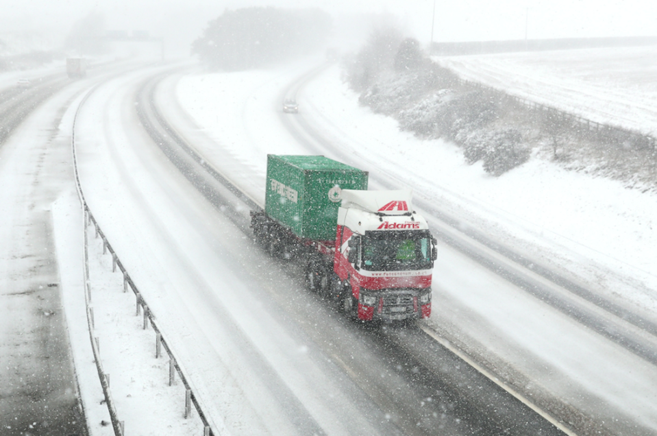 <em>A lorry makes its way along a desolate M9 near Falkirk during a snow blizzard (PA)</em>